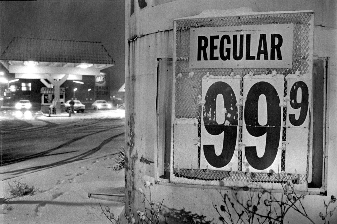 Foto einer Tankstelle im Schnee mit einem Schild, auf dem der Preis für eine Gallone Benzin steht. Das Bild illustriert, was nach den Zinserhöhungen mit der Preisentwicklung passierte. Es war eine Maßnahme, um Inflation zu bekämpfen.