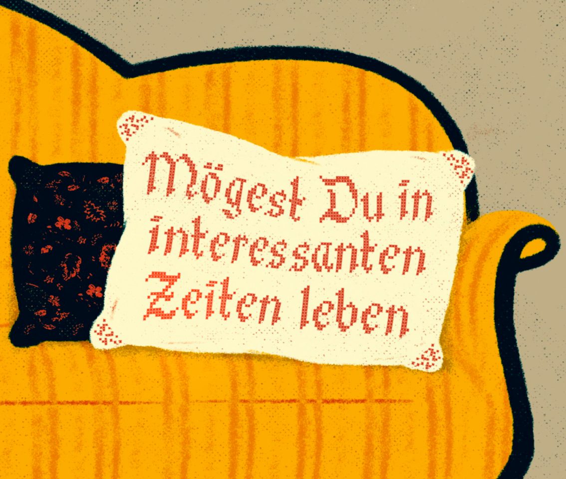 Die Illustration über Deutschlands Krisen zeigt ein Sofa auf dem ein Kissen mit der Aufschrift „Mögest Du in interessanten Zeiten leben.“